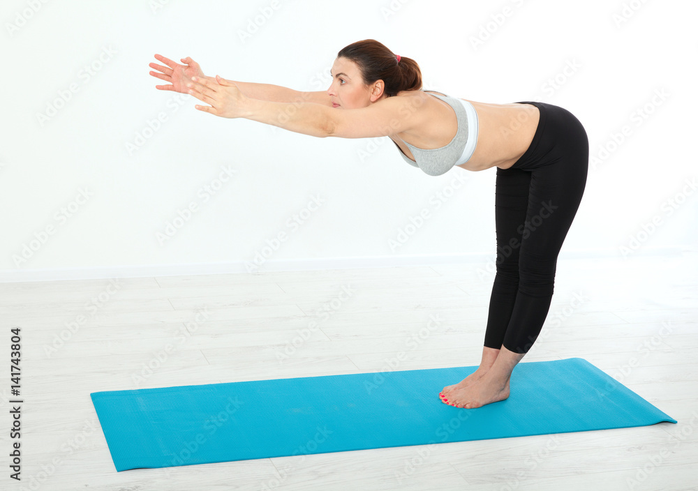 Sport. Fitness Yoga woman. Beautiful middle-aged woman doing yoga poses. Concept people are workout in yoga, training in sports clothes in home interior Sport. Fitness Yoga woman. Beautiful middle-aged woman doing yoga poses. Concept people are workout in yoga, training in sports clothes in home interior