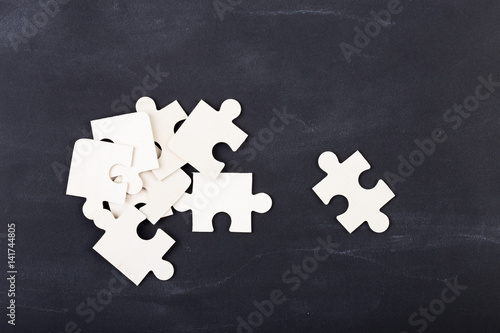 Business solution concept jigsaw on the blackboard
