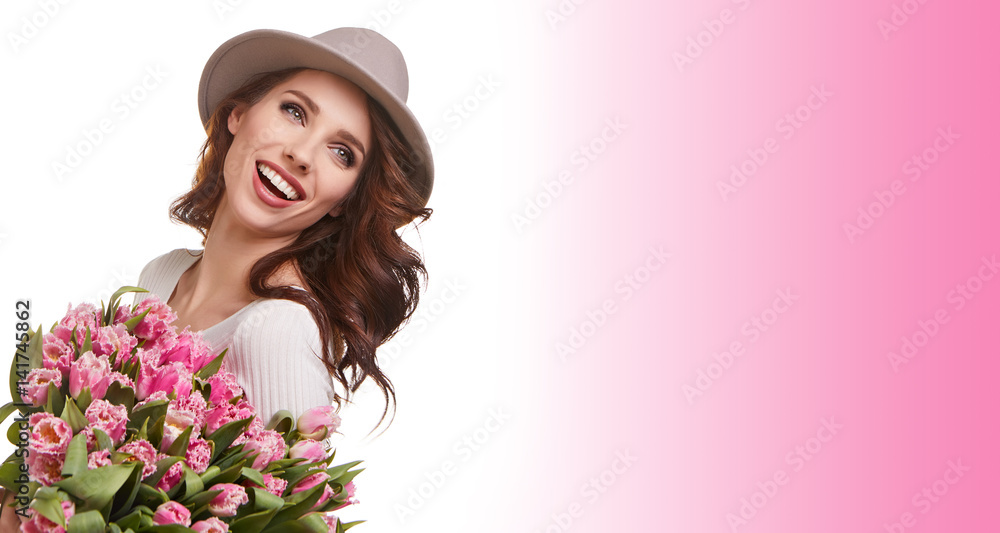 portrait of a beautiful young woman with purple tulips standing on the white background portrait of a beautiful young woman with purple tulips standing on the white background