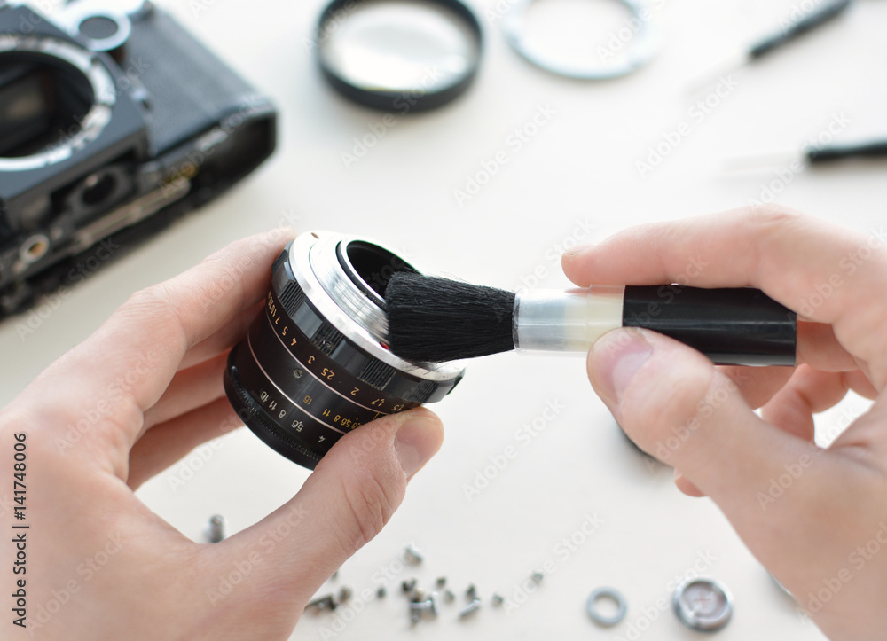The engineertechnician checks the optics and carries out maintenance