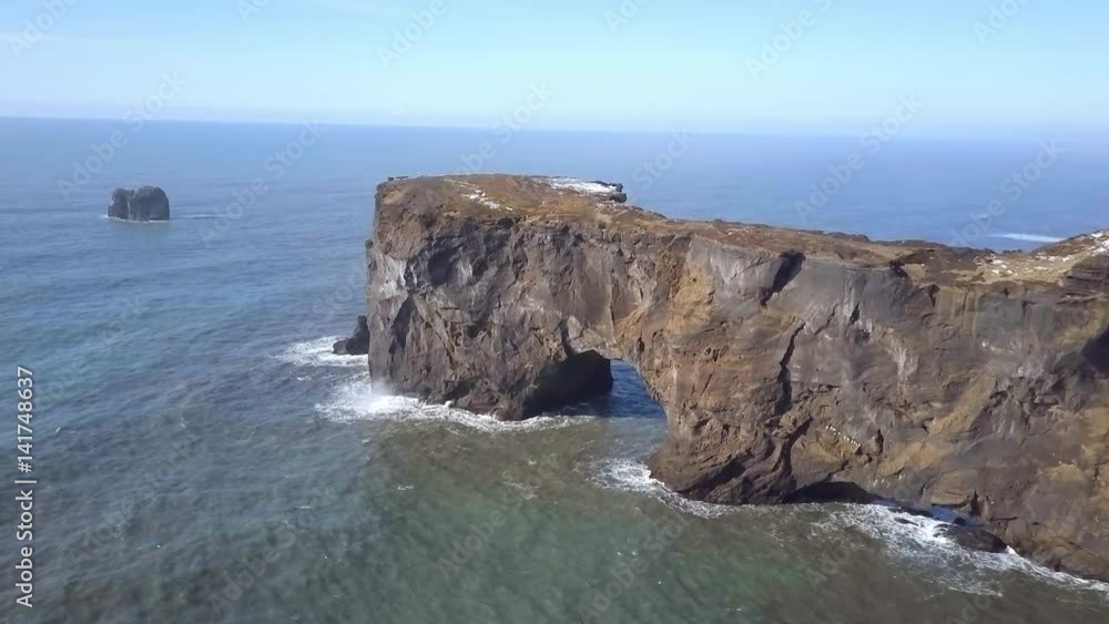 Dyrholaey Arch A Natural Rock Formation on the Coast of Iceland From the Air Dyrholaey Arch A Natural Rock Formation on the Coast of Iceland From the Air