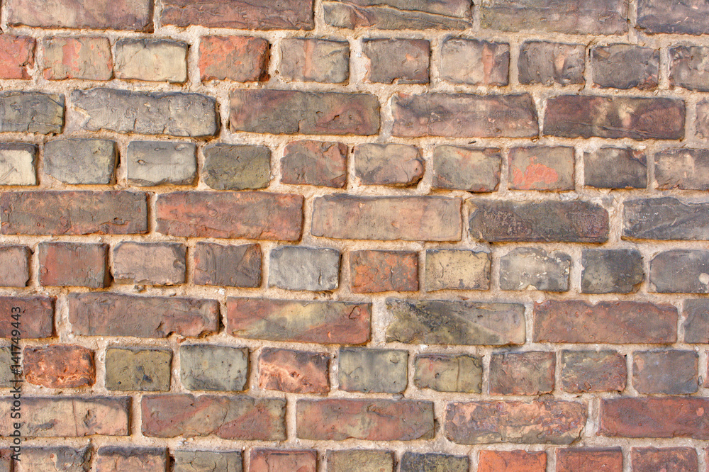 Old empty uneven raw varied color brick wall Old empty uneven raw varied color brick wall