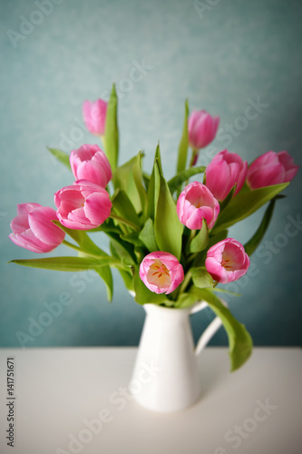 Bouquet of pink tulips in a white vase