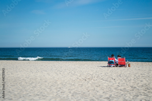 Couple in Chairs by the Beach – Summer in the Hamptons, USA
