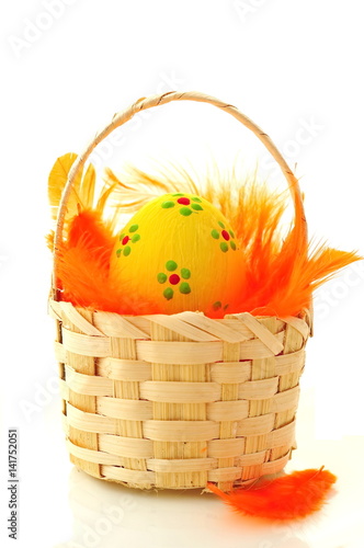 Colored Easter egg with orange feathers 