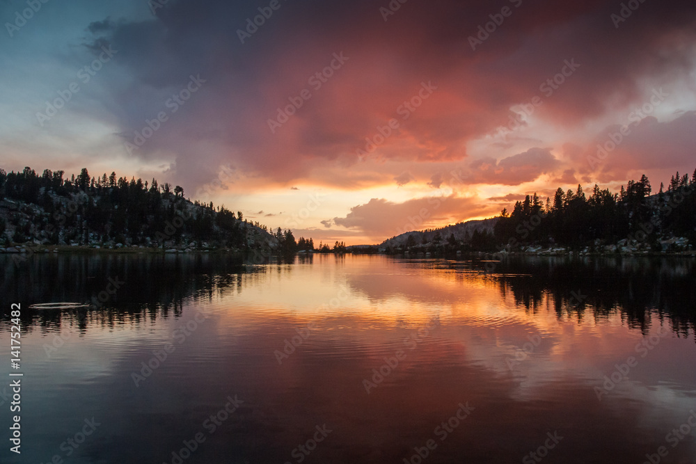 Colorful sunset reflection in a lake in the Sierra Nevada of California