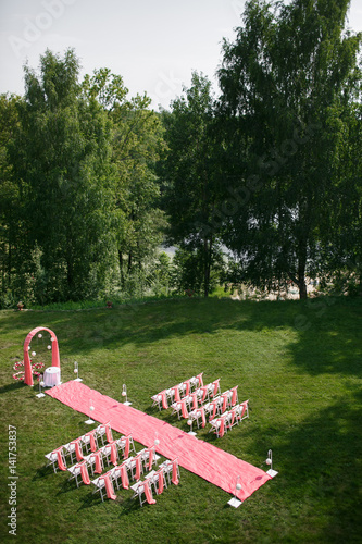 Wedding registration beautiful in nature. White chairs for visiting registration. Pink tent with white flowers for the exit registration. Wedding details photo