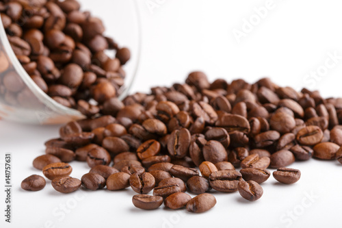 roasted coffee beans isolated in white background. Roasted coffee beans background close up. Coffee beans pile from top on white background with copy space for text. Good morning.