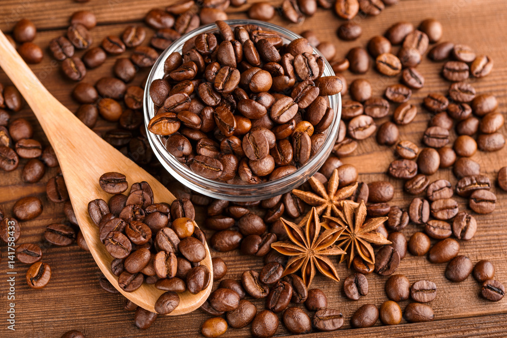 Coffee beans and cinnamon on a background of burlap. Roasted coffee beans background close up. Coffee beans pile from top with copy space for text. Seasoning. Spice. Cinnamon. Badian. Coffee house. Coffee beans and cinnamon on a background of burlap. Roasted coffee beans background close up. Coffee beans pile from top with copy space for text. Seasoning. Spice. Cinnamon. Badian. Coffee house.