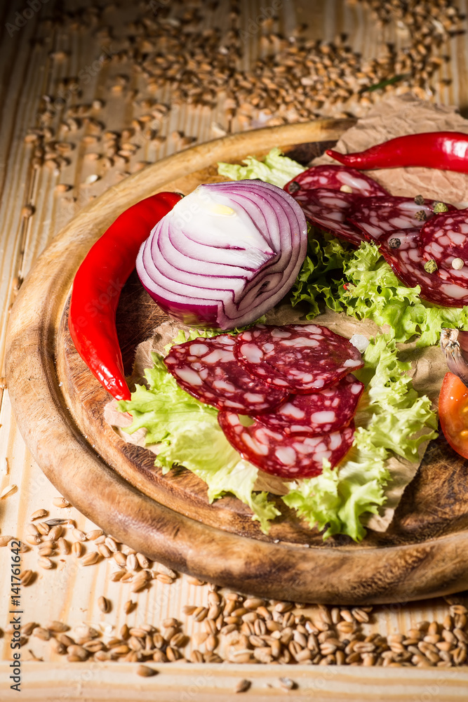 Sliced tasty Chorizo sausage over the wooden background
