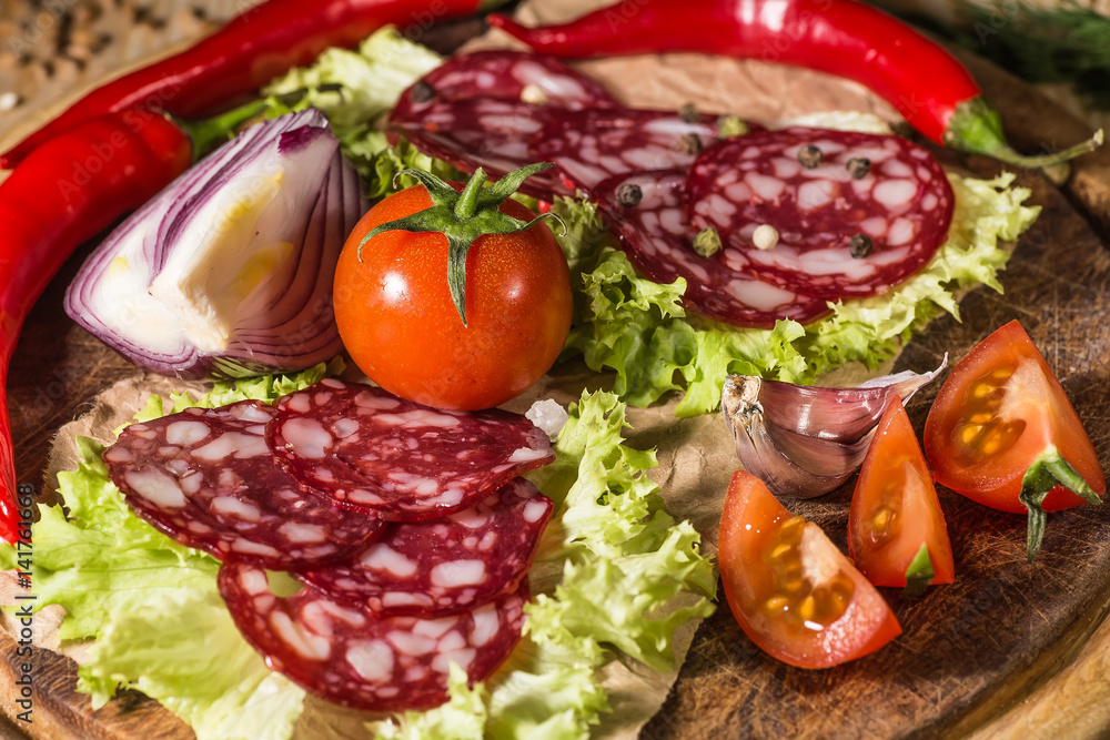 Sliced tasty Chorizo sausage over the wooden background Sliced tasty Chorizo sausage over the wooden background