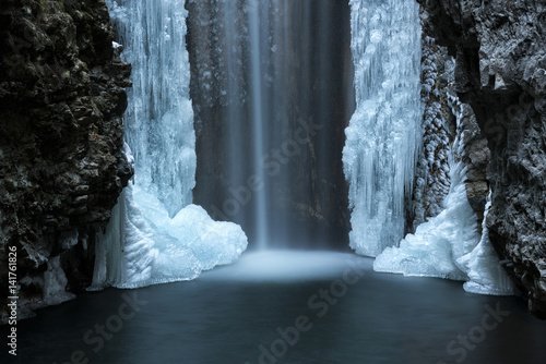 Waterfall from Smeraldo lake in winter, Non Valley, Trentino Alto Adige, Italy. photo