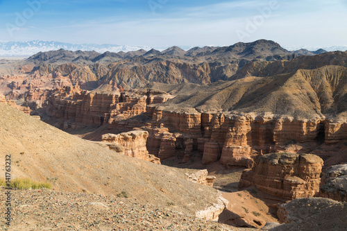 Sharyn Canyon panorama.
Panorama of the Valley of Castles in the Sharyn Canyon National Park, Kazakhstan. Snow-capped Tian Shan mountain range is in the background. Early spring sunny day.