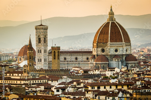 Florence, Tuscany, Italy. cityscape and Cathedral and Brunelleschi Dome, Giotto Tower. Sunset, lights on. photo