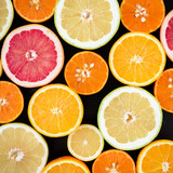 Lemon, orange, mandarin, grapefruit, sweetie and pomelo on black background. Flat lay, top view. Fruit colorful background