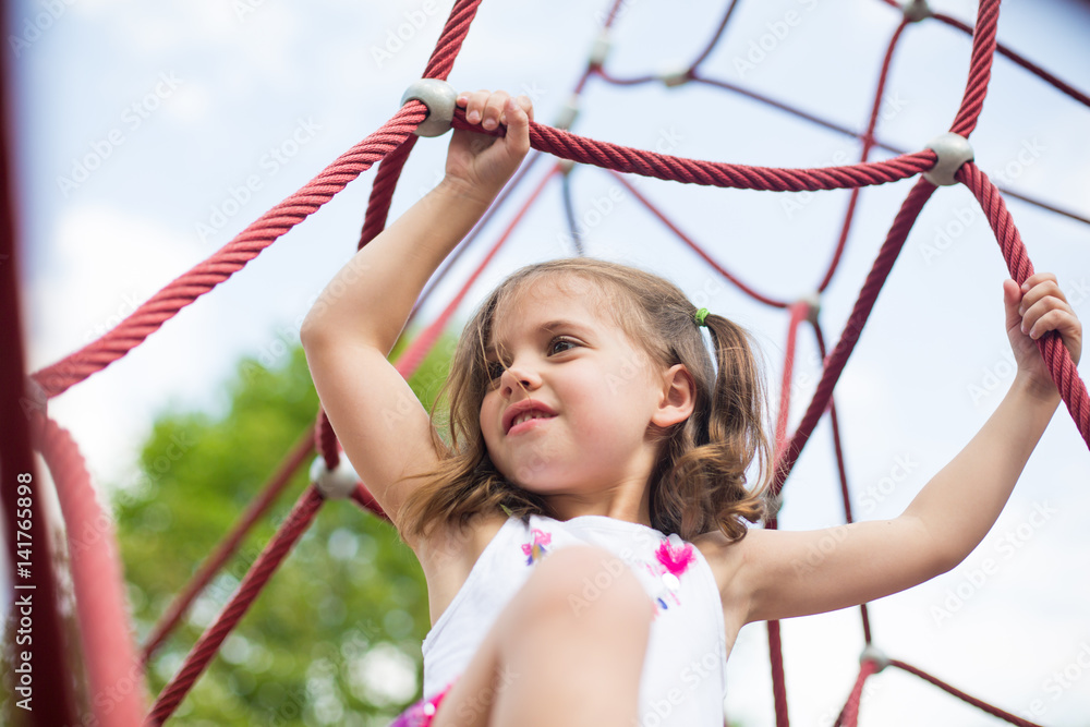 Girl holding ropes in playground Girl holding ropes in playground