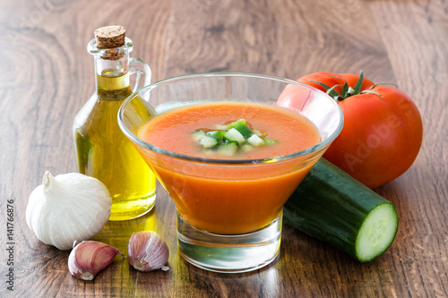 Traditional Spanish cold gazpacho soup and ingredients on wooden table
 photo