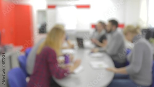 Intentionally blurred office. Business people at round tables in talks