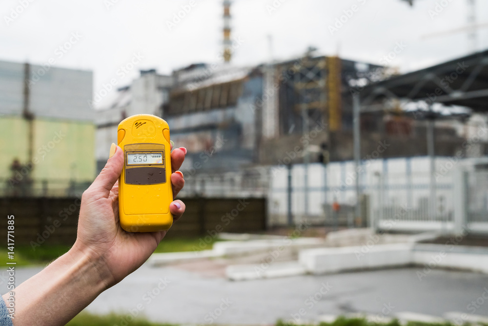 radiometer in hand with fourth Chernobyl reactor on the background radiometer in hand with fourth Chernobyl reactor on the background