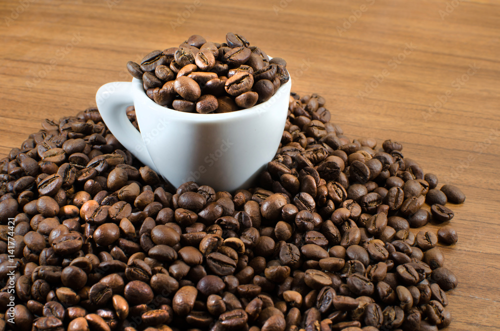 roasted coffee beans in a coffee cup. can be used as background