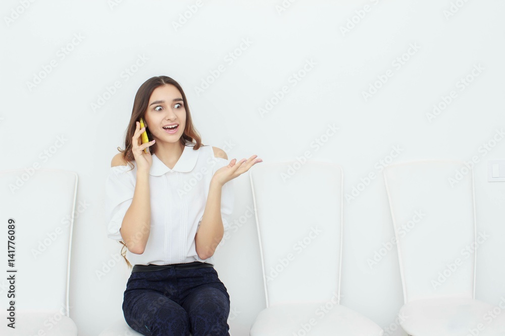 Young business woman sitting on chair and using mobile phone Young business woman sitting on chair and using mobile phone