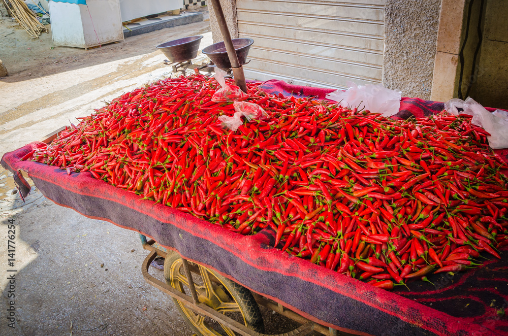 Red chilli or peppers stacked on sales trolly in soukh of medina, Fez, Morocco