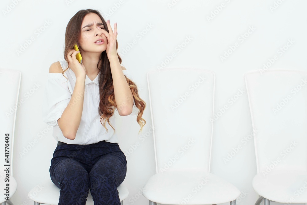 Young business woman sitting on chair and using mobile phone Young business woman sitting on chair and using mobile phone