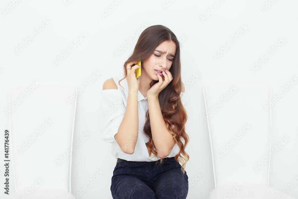 Young business woman sitting on chair and using mobile phone Young business woman sitting on chair and using mobile phone