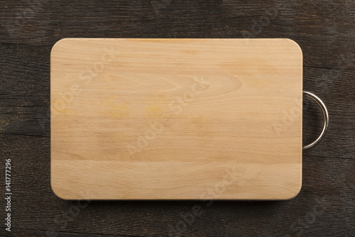 Chopping board on wooden background