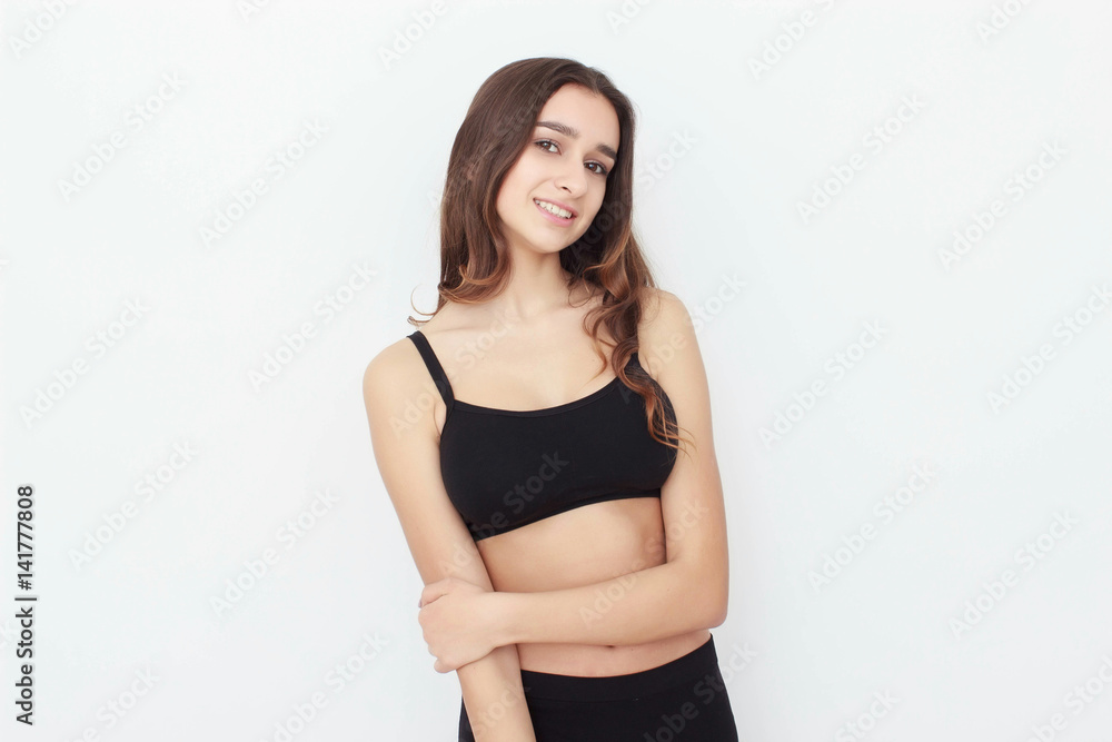 Beautiful girl in black top on white background shows emotion Beautiful girl in black top on white background shows emotion