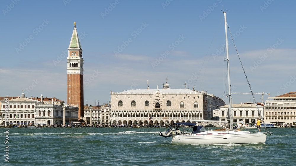 Sailing with a beautiful luxury catamaran on the Venetian lagoon with Piazza San Marco in the background, Venice, Italy