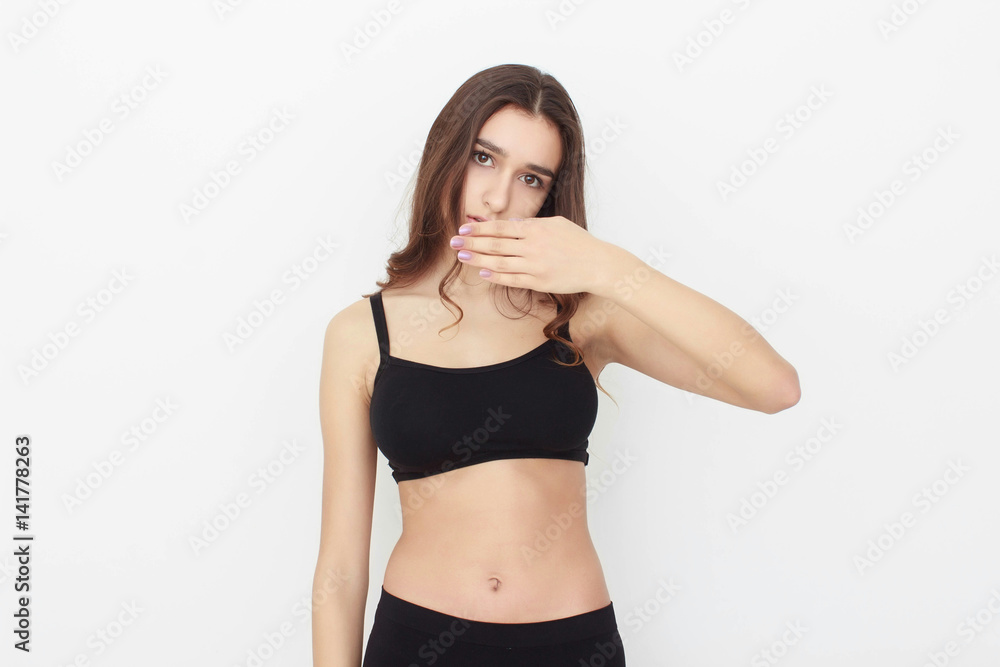 Fototapeta premium Beautiful girl in black top on white background shows emotion