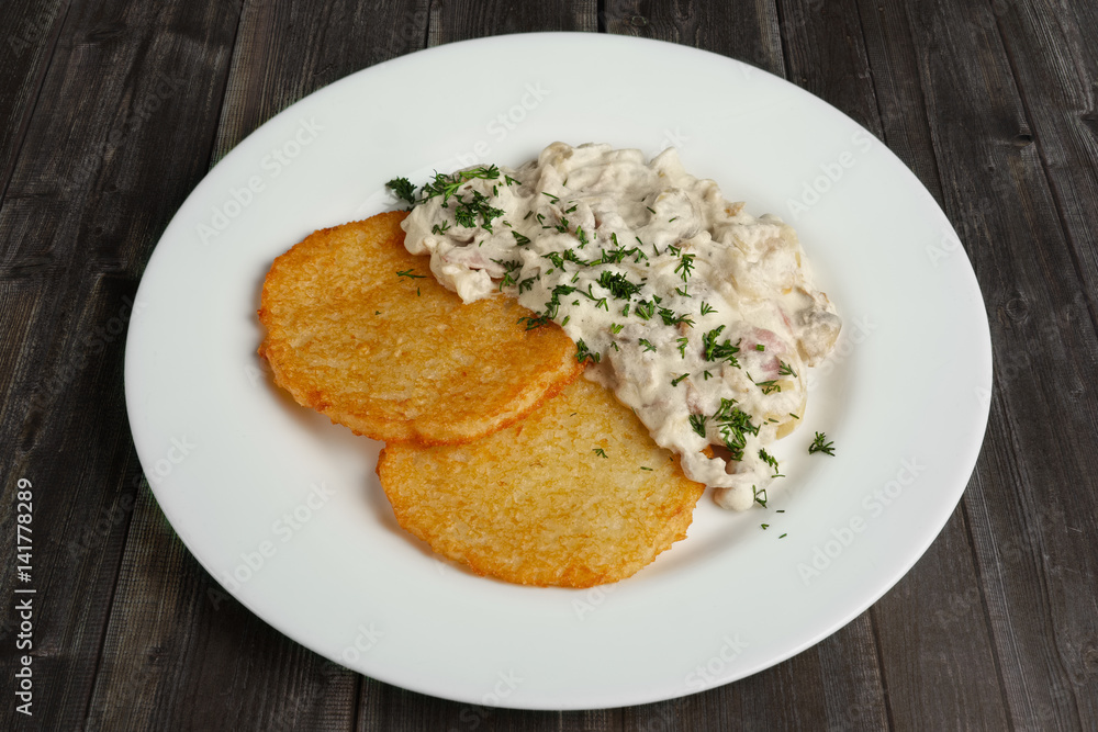 Top view of plate with draniki and mushroom cream sauce Top view of plate with draniki and mushroom cream sauce