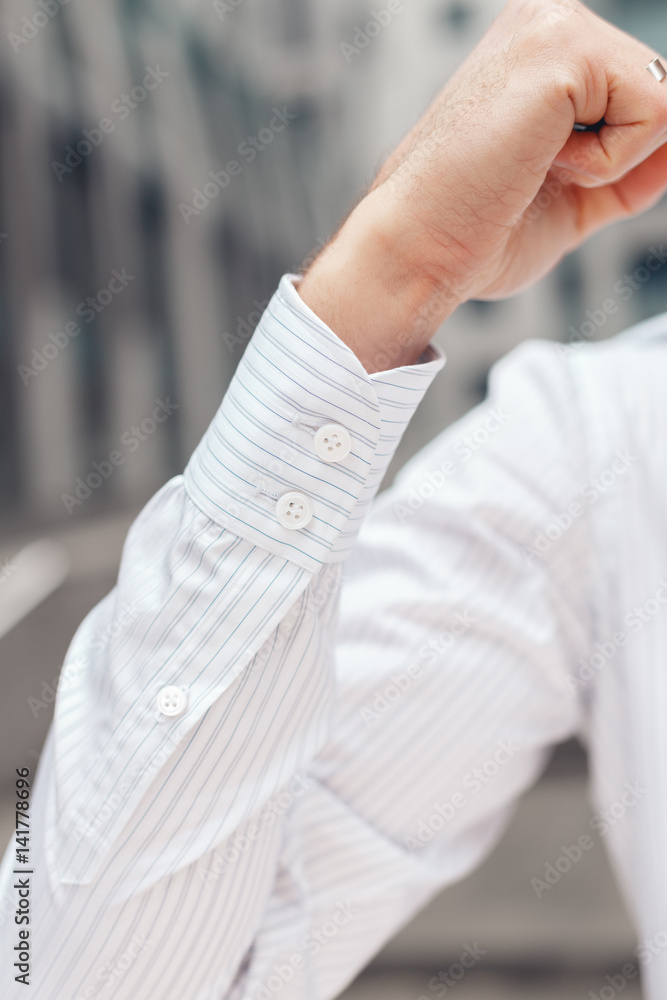 Close up of a businessman's shirt cuffs. Closeup of a hand man how wears white shirt and cufflink.