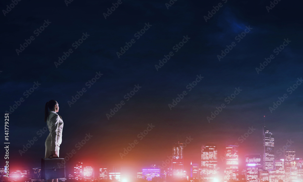 Woman looking at night city Woman looking at night city
