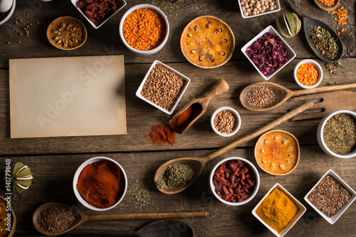Various colorful spices on wooden table. Place for typography and logo