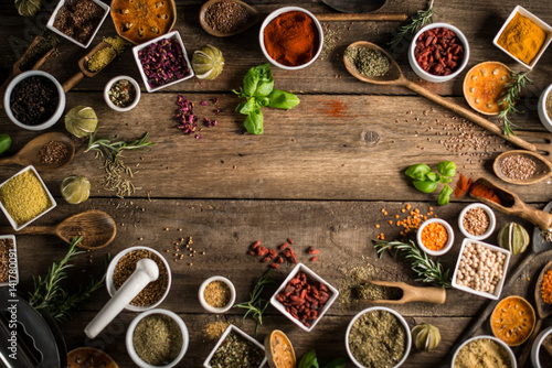 Fototapeta Naklejka Na Ścianę i Meble -  Various colorful spices on wooden table. Place for typography and logo