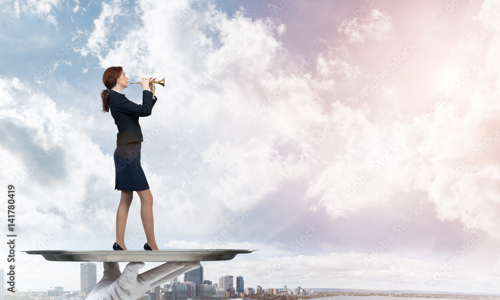 Attractive businesswoman on metal tray playing fife against cityscape background