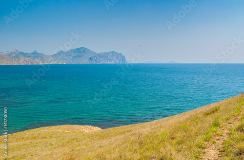 Landscape with view from Meganome cape to Kara-Dag volcanic mountain range on Crimean peninsula