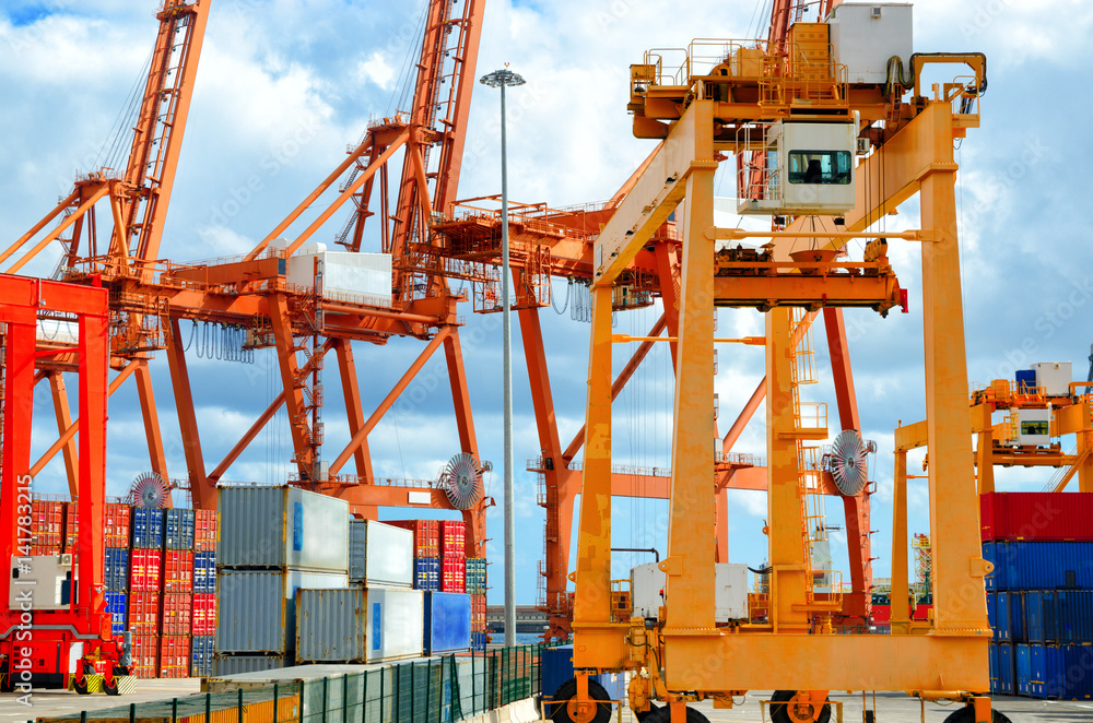 Industrial harbor, gantry cranes and container ship. Industrial cranes in port of Santa Cruz de Tenerife. Canary Islands, Spain.
