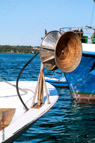 Back of a wheel on fishing boat with all its collected networks, part of. Wheel on for collecting ropes. Back of a fishing boat with all its collected networks.