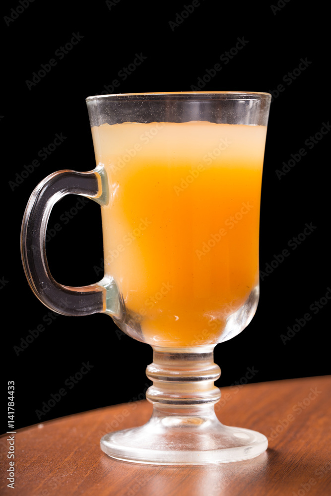 Glass glass with mango juice on a black background Glass glass with mango juice on a black background