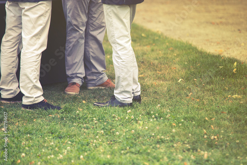 Close up on people in queue on grass