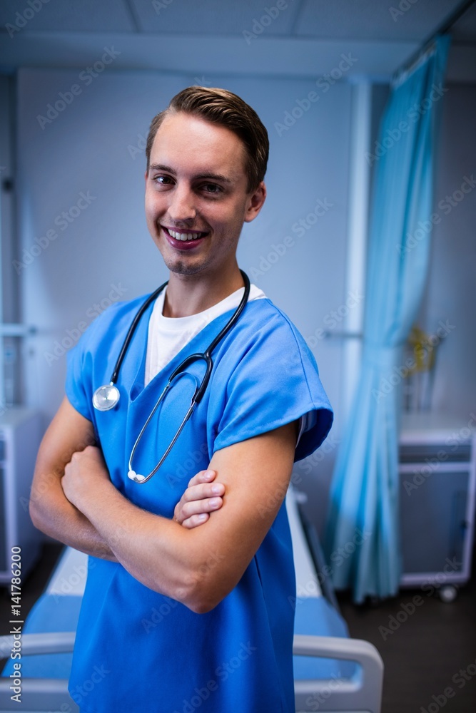Portrait of male doctor standing with arms crossed in ward Portrait of male doctor standing with arms crossed in ward