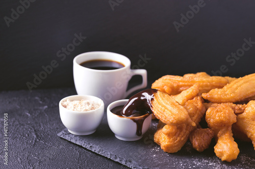 Traditional Spanish dessert churros with hot chocolate and coffee