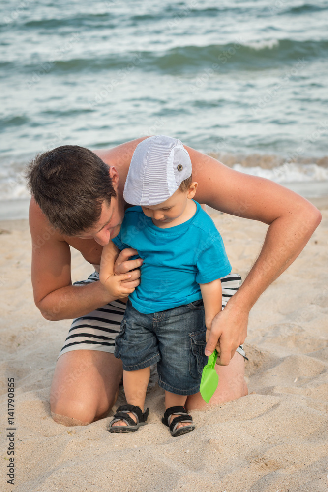 father and son playing at the beach father and son playing at the beach