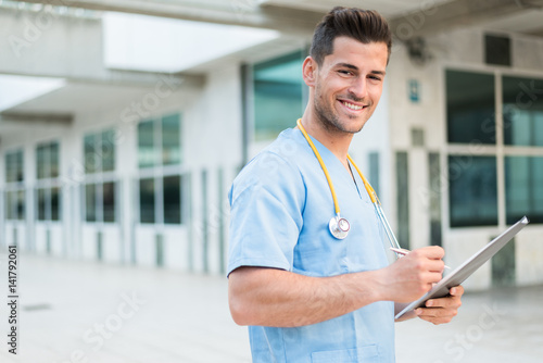 male nurse vet with stethoscope and tablet