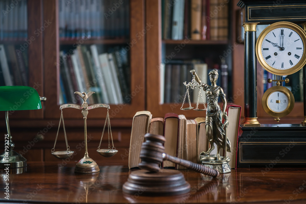 Law and Justice concept with gavel and scale in background. Composition in court library