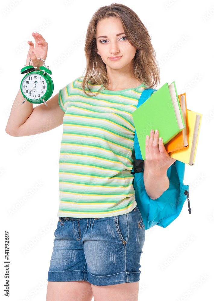 Beautiful student girl with backpack, books and alarm clock, isolated on white background Beautiful student girl with backpack, books and alarm clock, isolated on white background