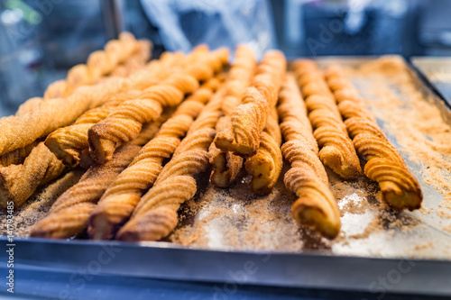Many long churros on display showing texture closeup